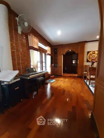 Spacious living room with wooden flooring and elegant decor in a cozy home setting.