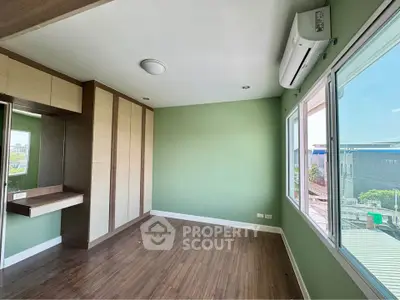 Spacious empty room with large windows and built-in wardrobe, perfect for customization.