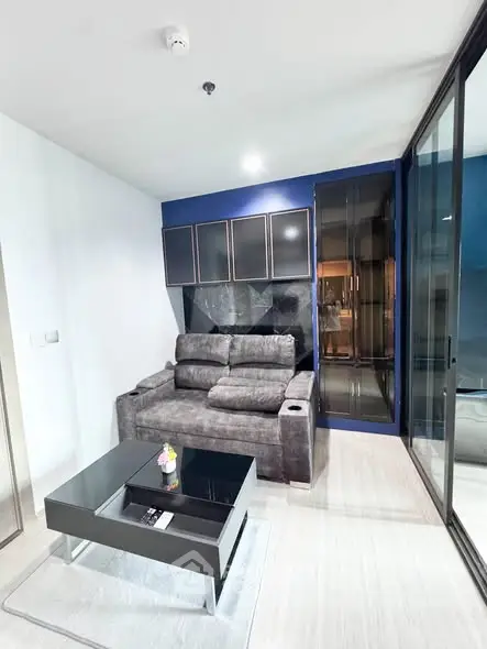 Modern living room with sleek furniture and glass partition