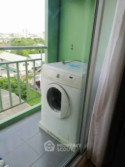 Compact balcony with washing machine and scenic view in modern apartment.
