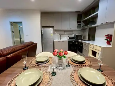 Modern kitchen and dining area with stylish appliances and elegant table setting.