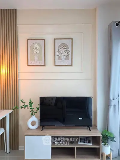 Modern living room with stylish decor and flat-screen TV on wooden stand