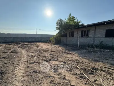 Spacious land plot with potential for development under clear blue sky.