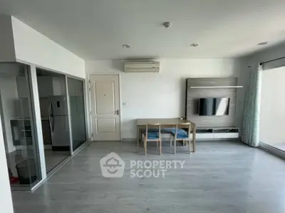 Modern living room with open layout and sleek furniture in a bright apartment