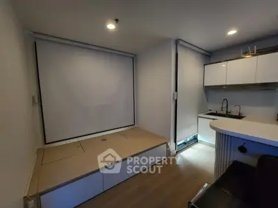 Modern compact living space with built-in storage and kitchenette