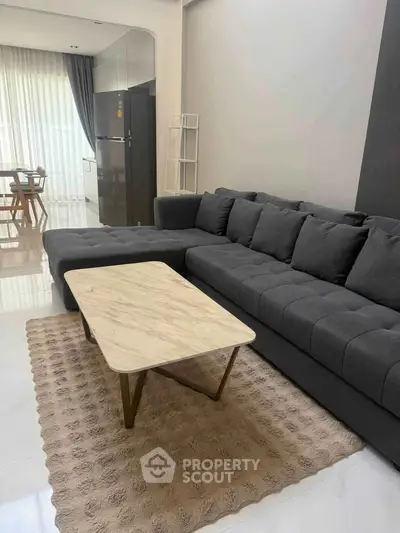 Modern living room with stylish gray sofa and elegant marble coffee table