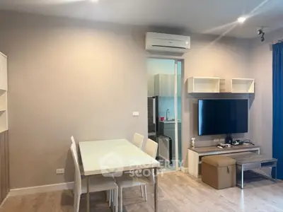 Modern living room with dining area and TV, featuring sleek furniture and neutral tones.