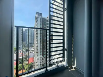 Modern balcony with city view in high-rise apartment building.