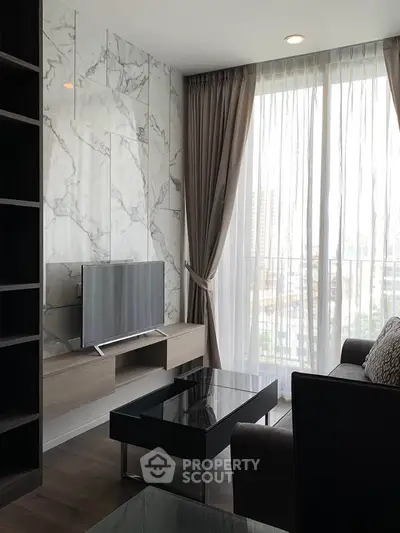 Modern living room with marble accent wall and large window offering city views.