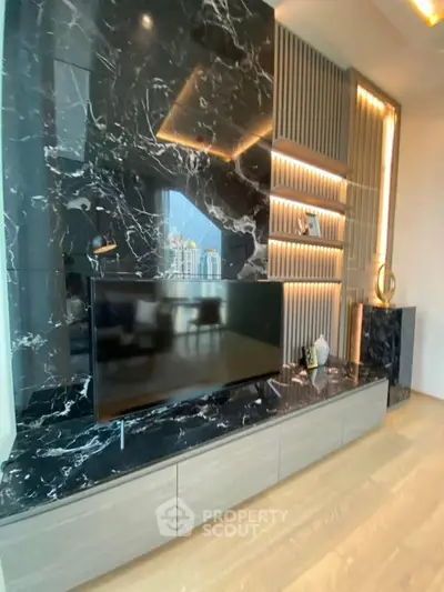 Luxurious living room with elegant marble wall and modern TV setup