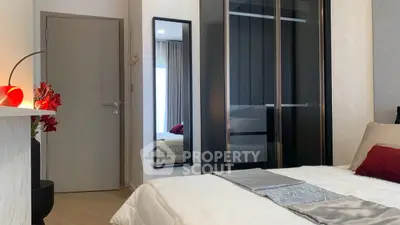 Modern bedroom with sleek black wardrobe and stylish decor