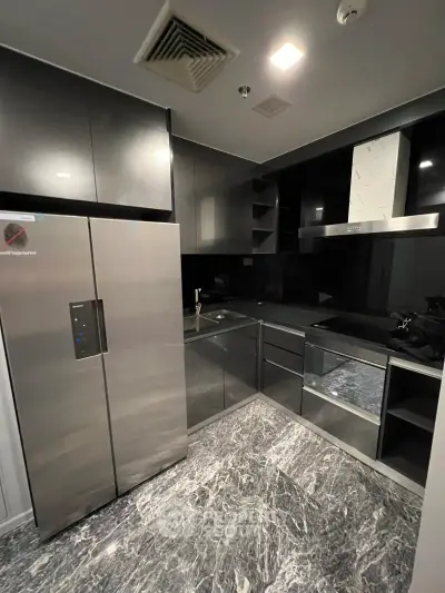Modern kitchen with sleek black cabinetry and stainless steel appliances