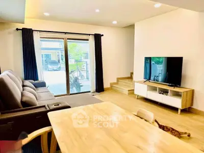 Spacious living room with modern furniture and large window for natural light.