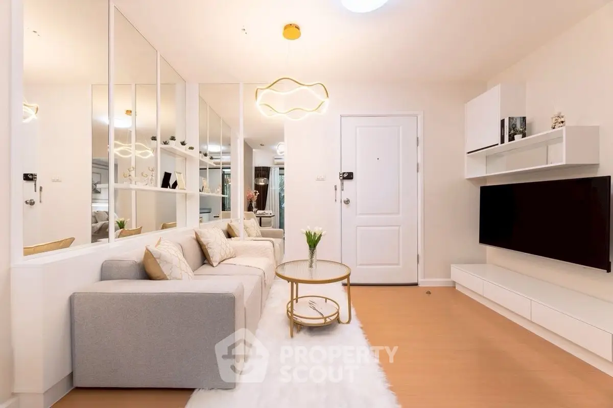 Modern living room with stylish decor, featuring a cozy sofa, sleek TV unit, and elegant lighting.