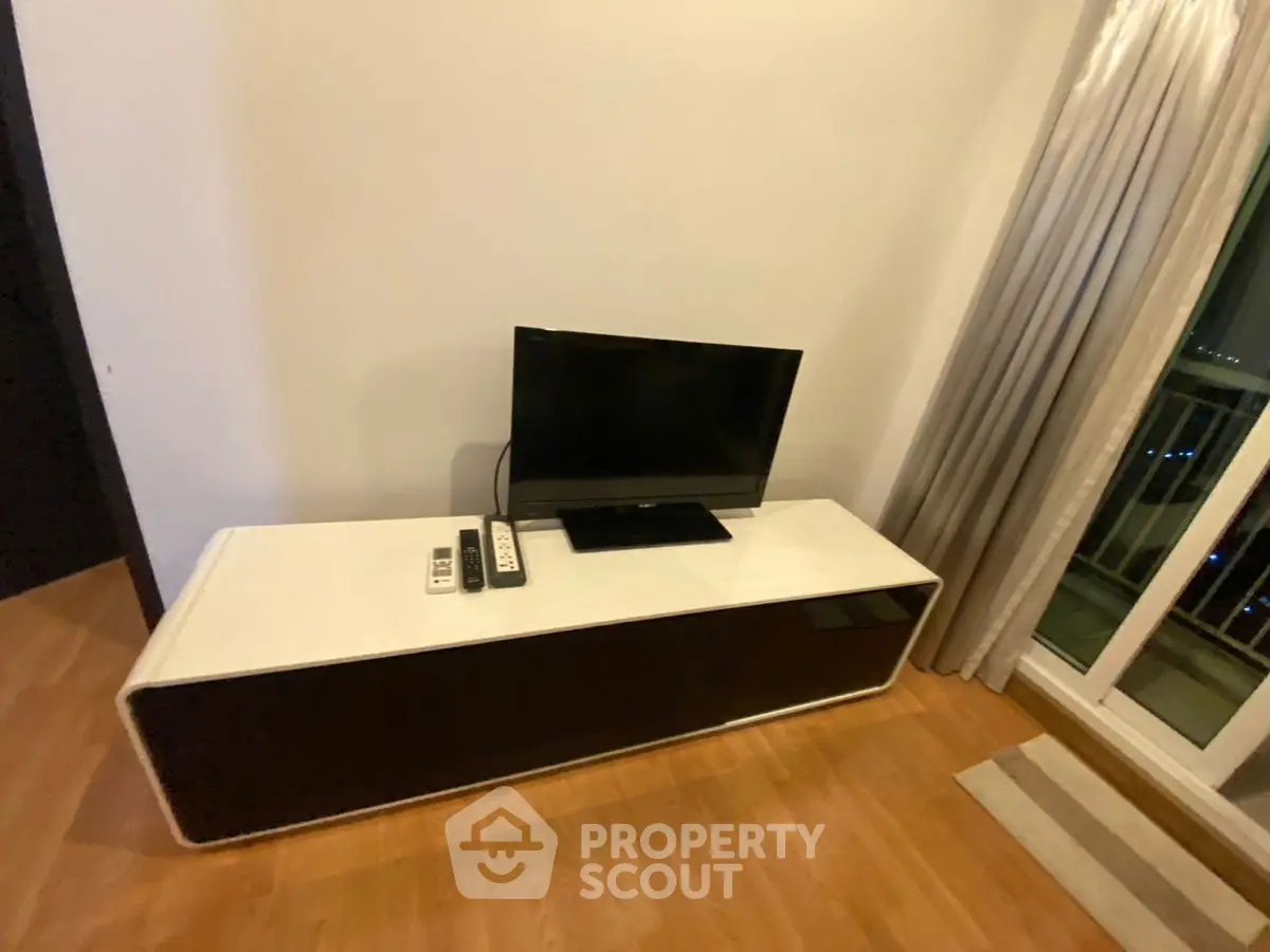 Modern living room with sleek TV stand and balcony view