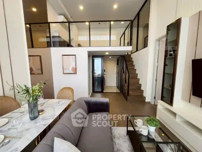 Luxurious modern living room with mezzanine, elegant decor, and open layout for sophisticated urban living.