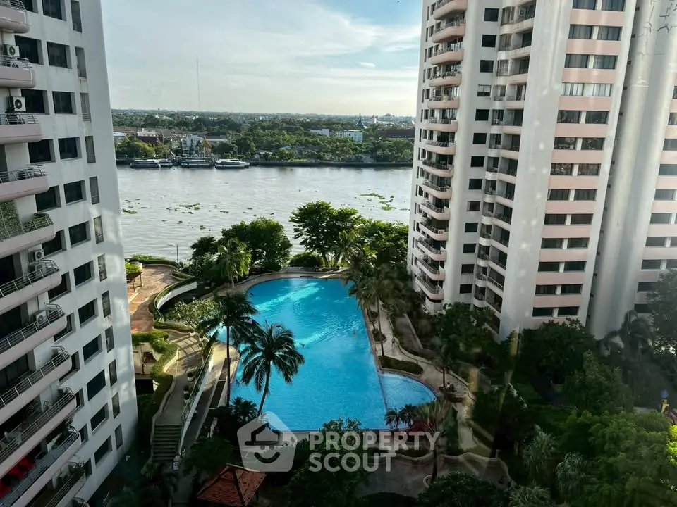 Stunning high-rise apartment view with pool and river backdrop, offering luxury urban living.