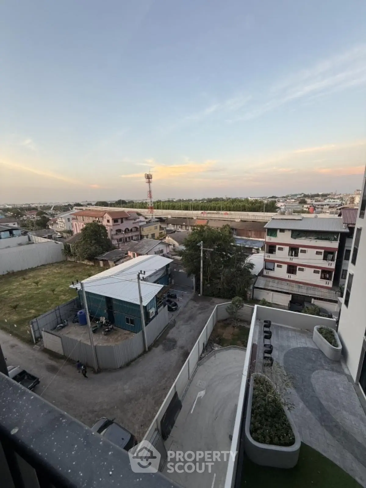 Stunning cityscape view from a high-rise balcony overlooking urban landscape and skyline.