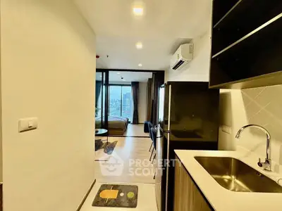 Modern apartment with open layout and city view, featuring sleek kitchen and cozy living area.