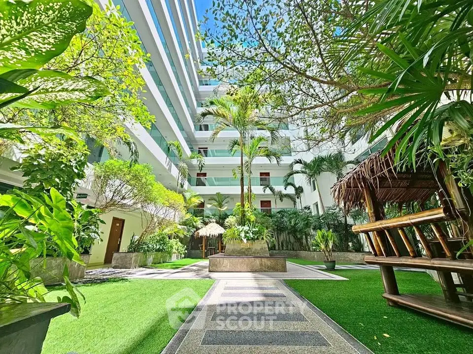 Luxurious apartment building with lush green courtyard and modern design