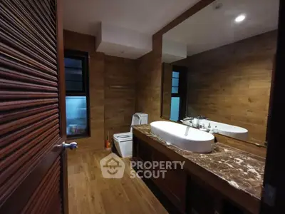 Luxurious bathroom with wooden accents and modern fixtures