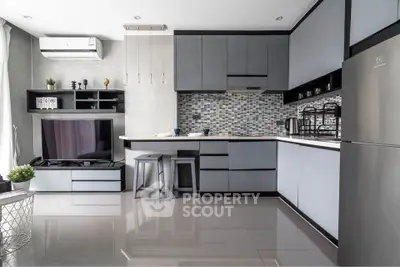 Modern kitchen with sleek cabinetry and stylish backsplash in a contemporary apartment.