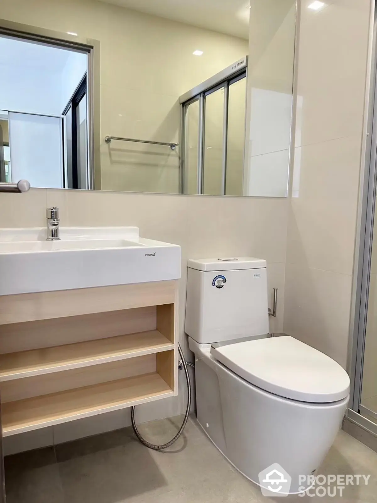 Modern bathroom with sleek fixtures and glass shower enclosure