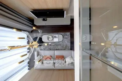 Modern living room with stylish chandelier and cozy sofa, perfect for relaxation and entertainment.