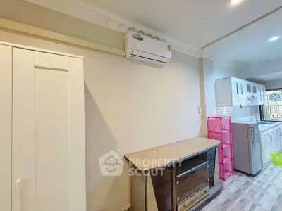 Spacious kitchen with modern appliances and ample storage in a cozy apartment.