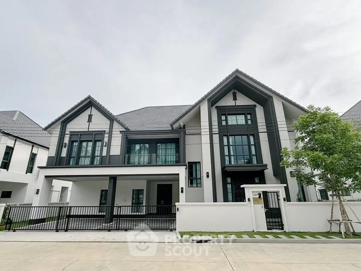 Stunning modern house with sleek design and spacious driveway in a serene neighborhood.