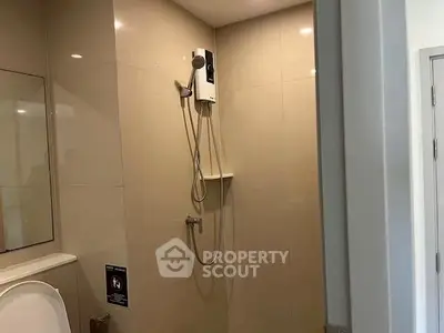 Modern bathroom with sleek shower and neutral tiles, perfect for a relaxing home experience.