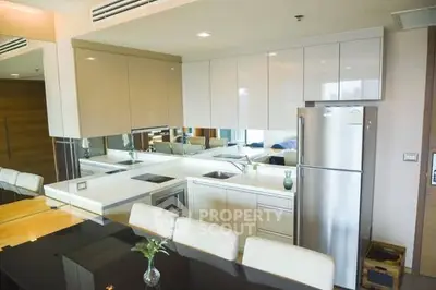 Modern kitchen with sleek cabinetry and stainless steel appliances in a stylish apartment.