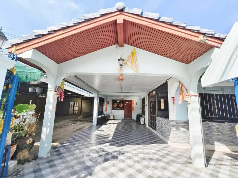 Charming single-story home with spacious covered patio and tiled driveway, perfect for outdoor gatherings.