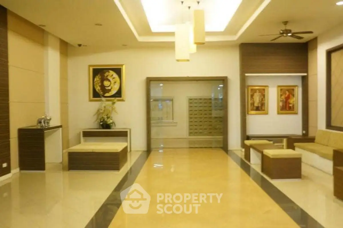 Elegant building entrance with modern decor and seating area