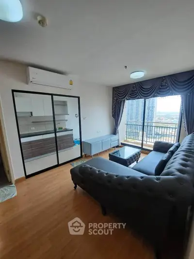 Modern living room with elegant sofa and balcony view in high-rise apartment