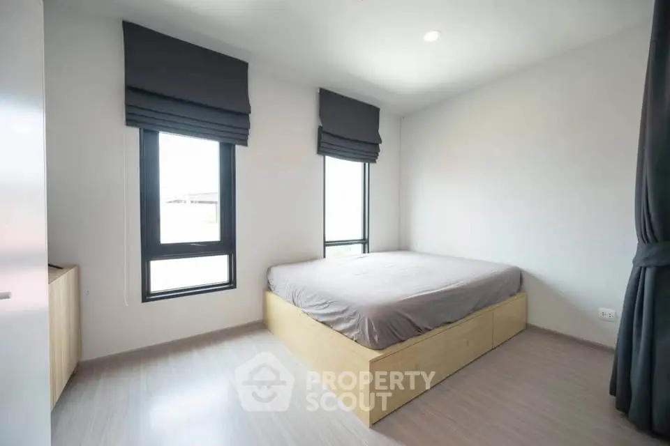 Modern minimalist bedroom with natural light and sleek design