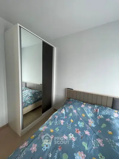 Cozy bedroom with floral bedding and sleek wardrobe design