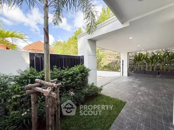 Spacious modern carport with lush greenery and sleek design