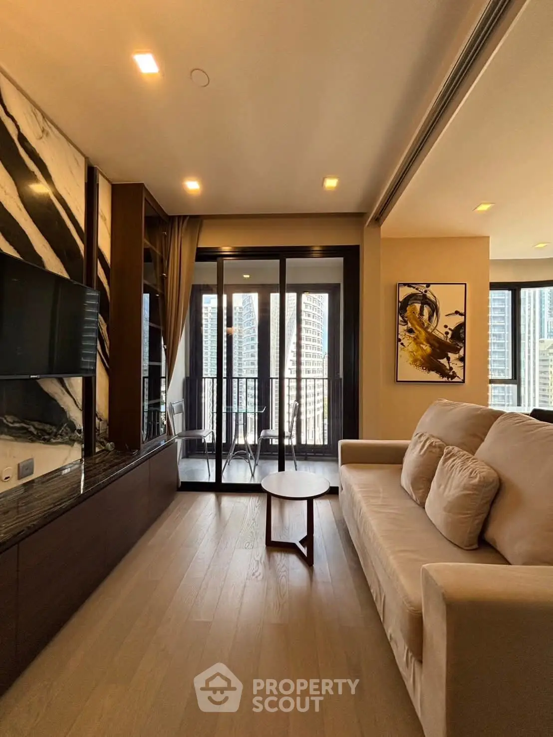 Luxurious living room with modern decor and stunning city view balcony.