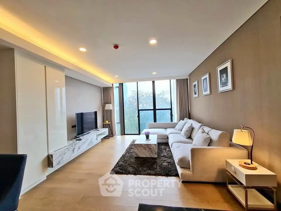 Spacious modern living room with large windows and stylish decor