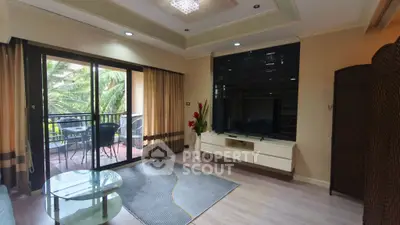Spacious living room with balcony access and modern decor in a tropical setting.