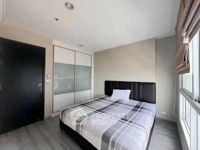 Modern bedroom with stylish decor and ample natural light