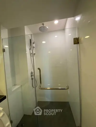 Modern bathroom with glass shower enclosure and rain showerhead