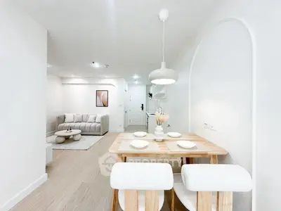 Modern open-plan living and dining area with stylish decor and neutral tones