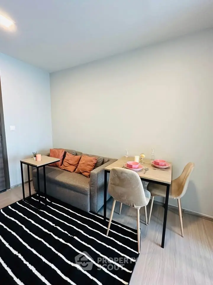 Cozy living room with modern furniture and dining area, perfect for urban living.