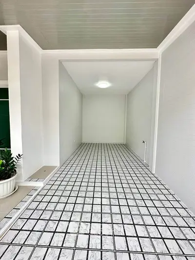 Spacious tiled storage area with modern design and bright lighting.