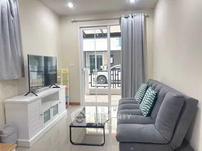 Modern living room with sleek furniture and large window for natural light.