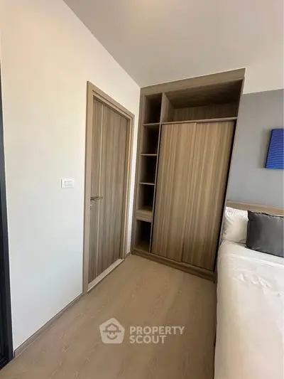 Modern bedroom with built-in wooden wardrobe and cozy bed