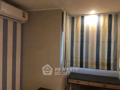 Cozy study room with striped curtains and air conditioning, perfect for focused work.