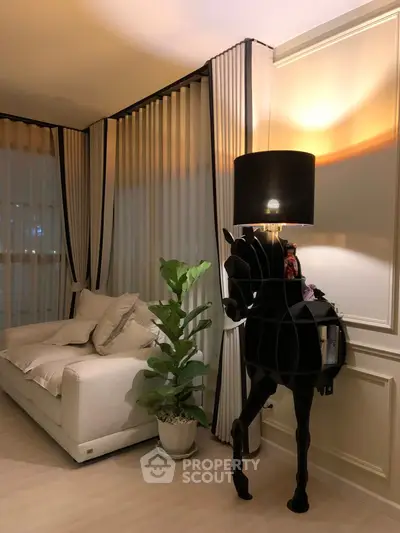 Elegant living room with modern decor, featuring a unique horse-shaped lamp and cozy sofa.